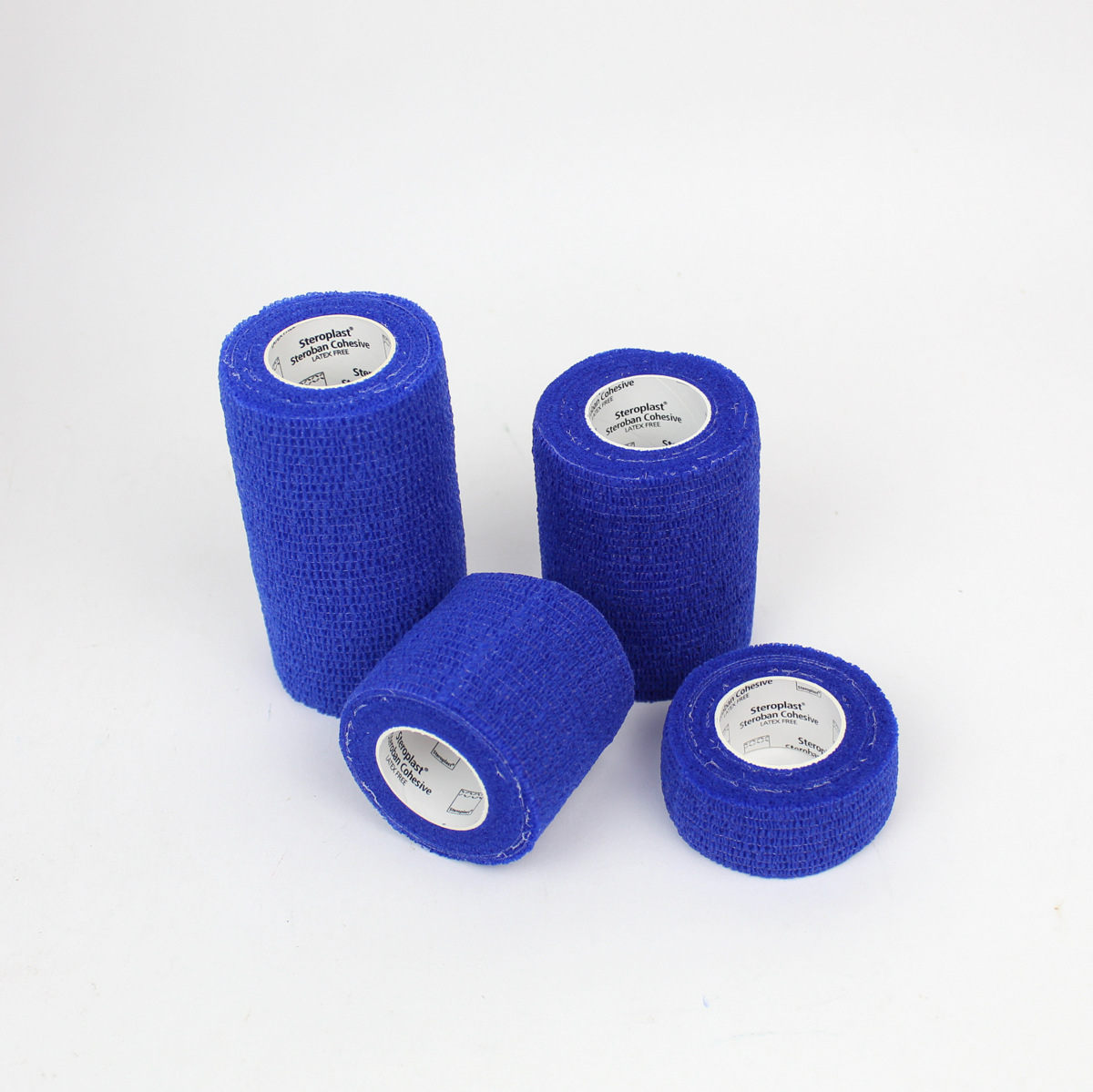 Four rolls of blue elastic bandage on a white background