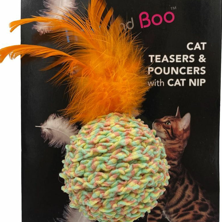 Cat toy with feathers and colorful ball on a black background