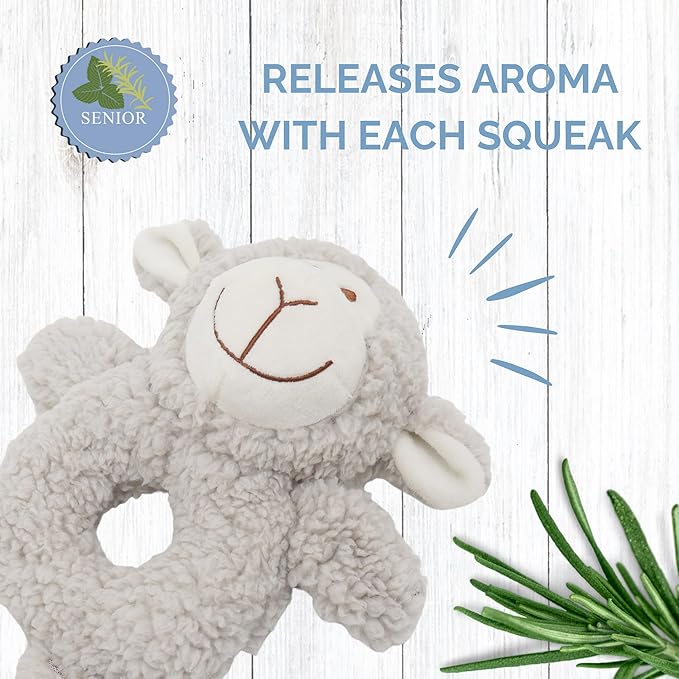 Gray sheep-shaped toy with a smiley face on a wooden background, featuring text about aroma release.