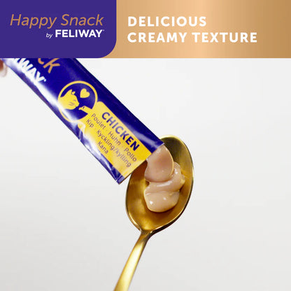 Happy Snack by FELIWAY chicken flavor cream on a spoon with packaging in the background