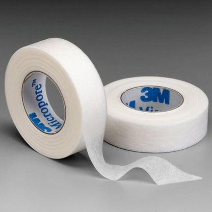 Two rolls of 3M Micropore tape on a gray background
