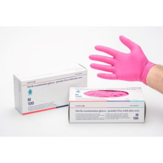 Pink nitrile examination gloves with boxes on a white background