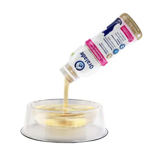 oralade RF being poured from a container into a transparent bowl on a white background