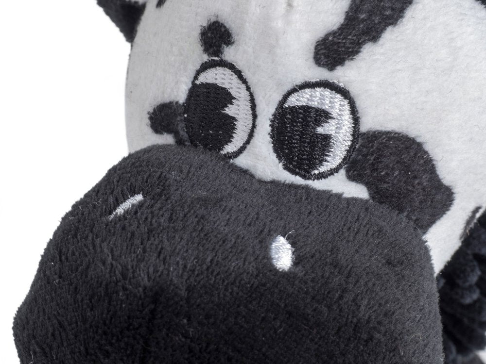 Close-up of a plush toy with a black and white face and gray body.