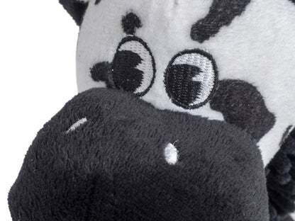Close-up of a plush toy with a black and white face and gray body.